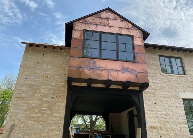 Copper metal panel facade on a stone building for Skylight Installation in Waxhaw